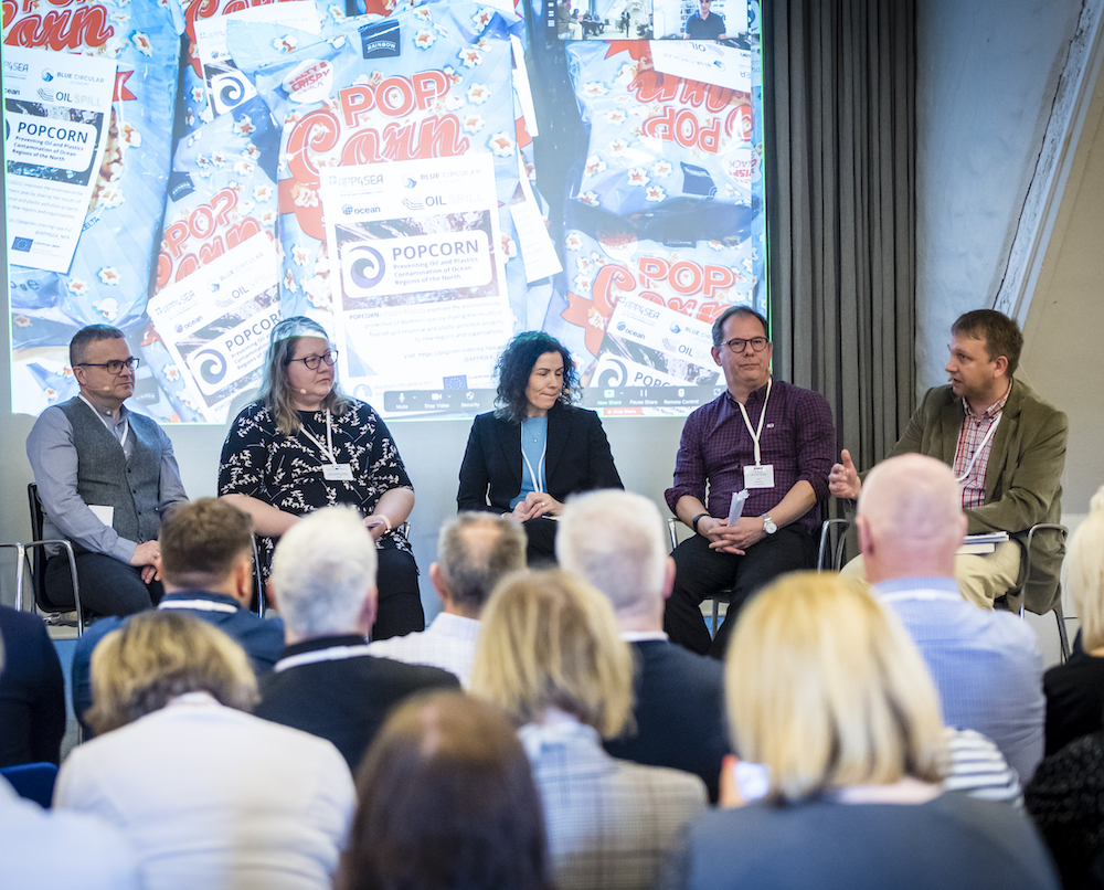 A panle of 5 speakers from Interreg NPA projects present in front of an audience