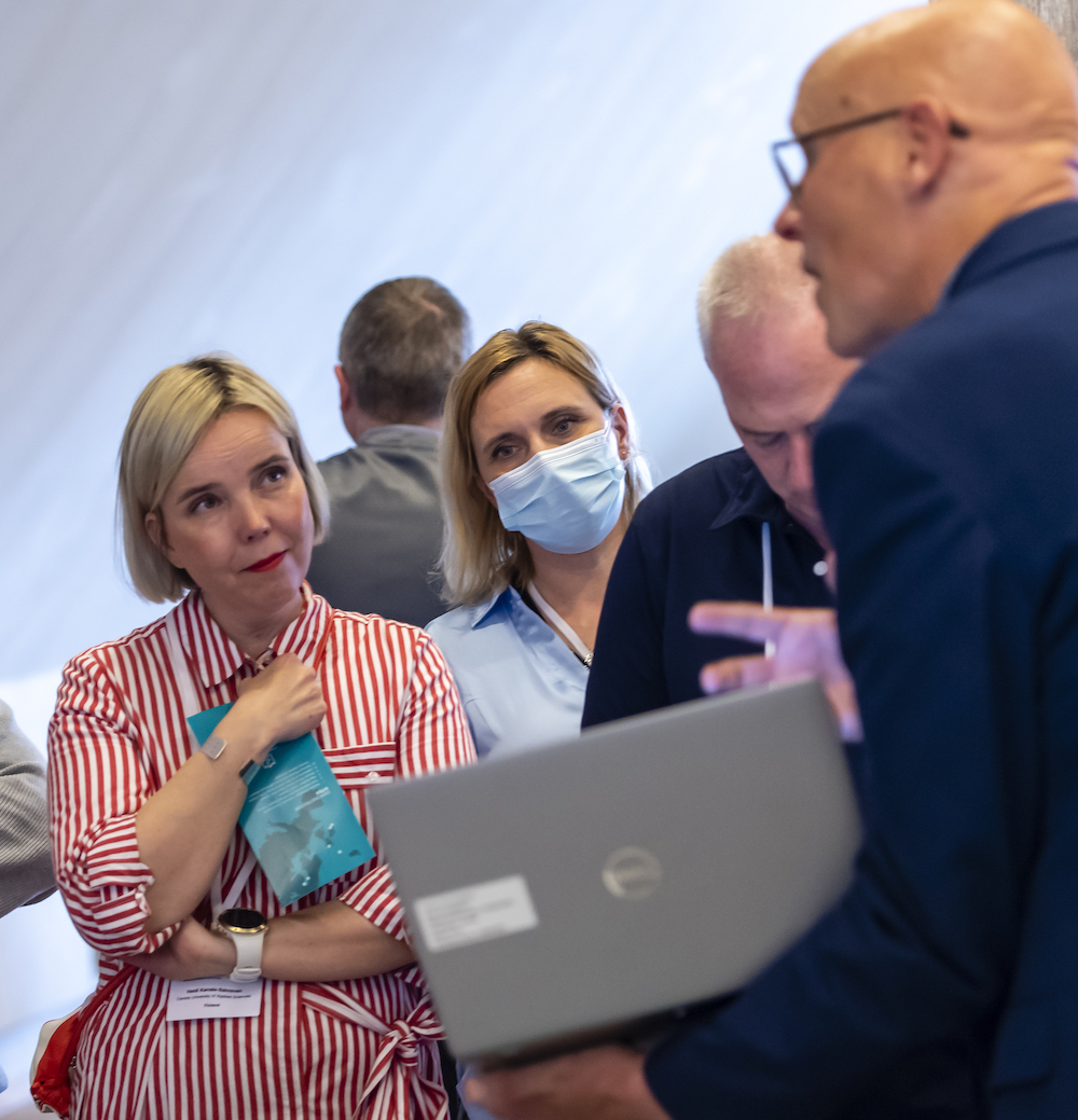 People listen to a man during an Interreg NPA event
