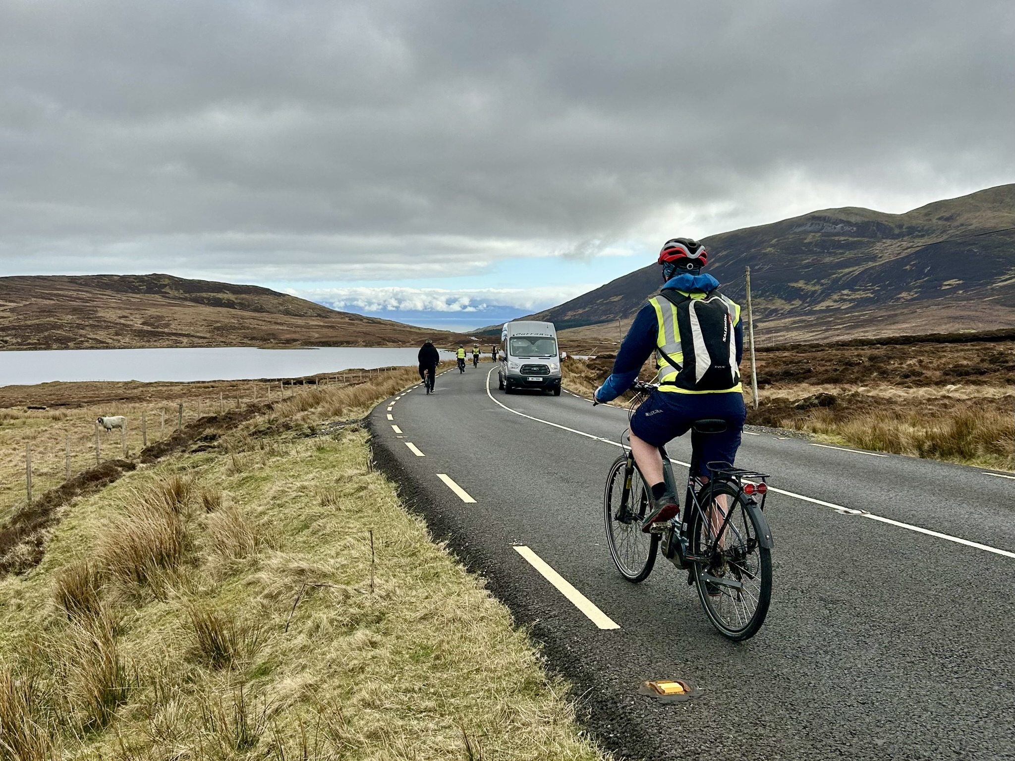Cycling tourists cycling away from the camera on the Donegal Road.